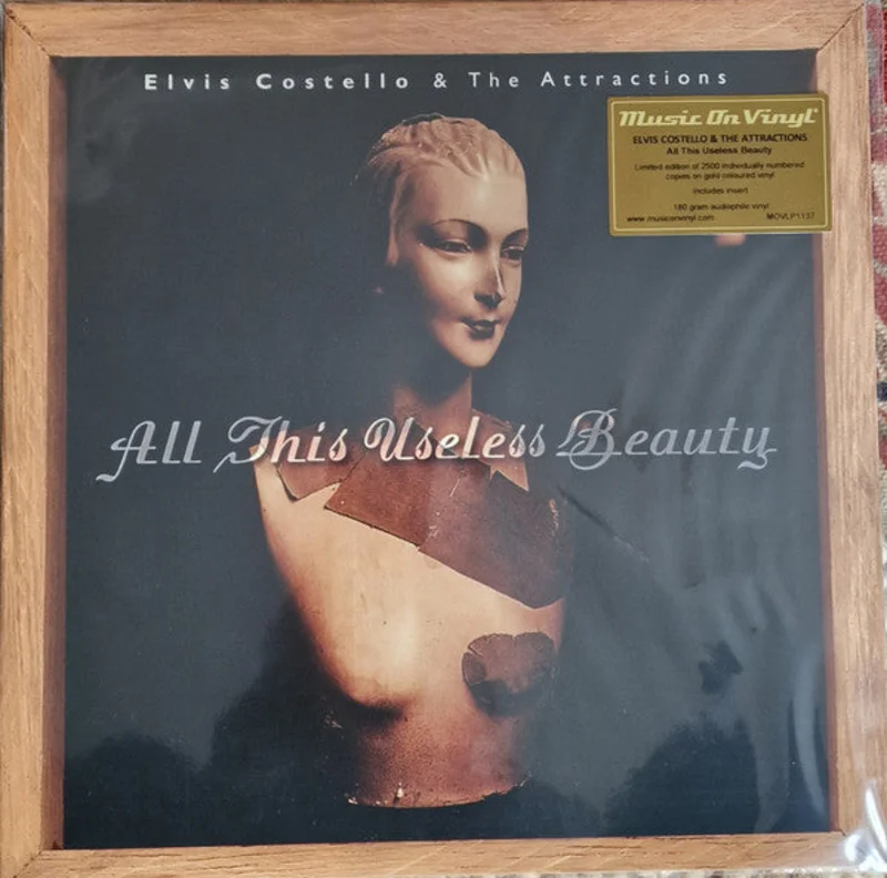 Elvis Costello & The Attractions - All This Useless Beauty (LP, Album, Ltd, Num, RE, Gol) (Mint (M))